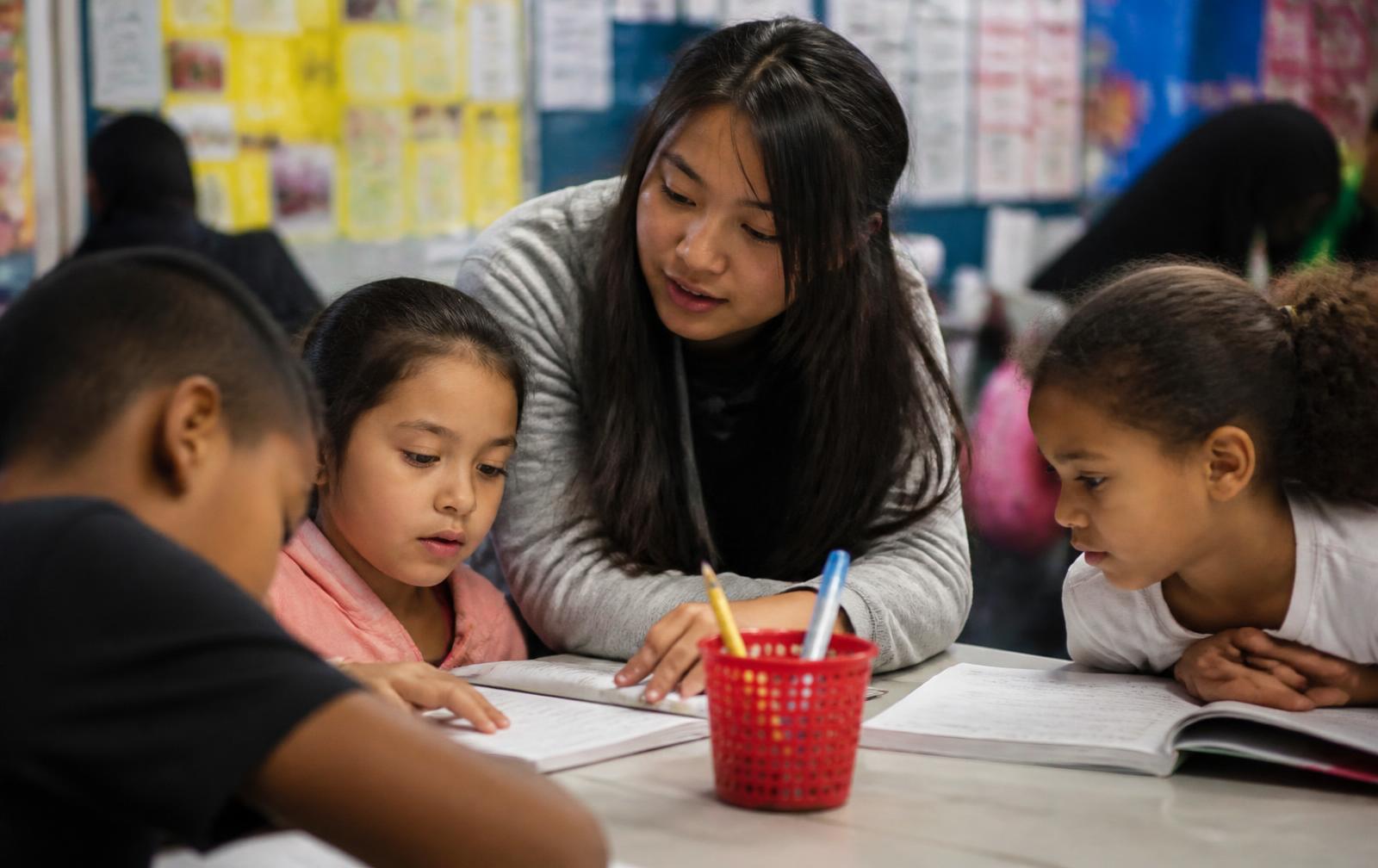 Children reading with a mentor at an after-school program